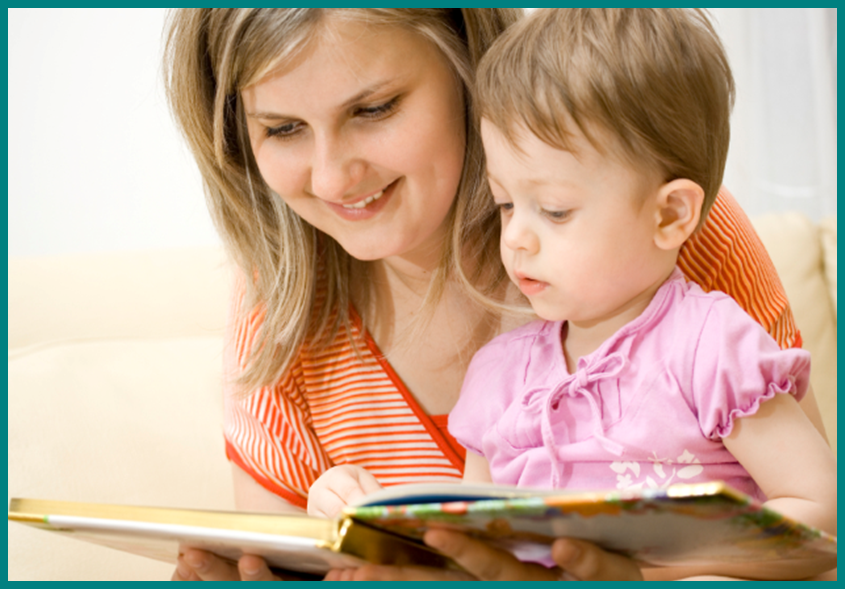 A mother reading a book to her toddler.