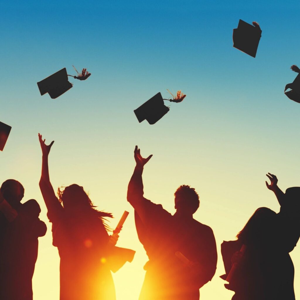 graduates throwing their caps