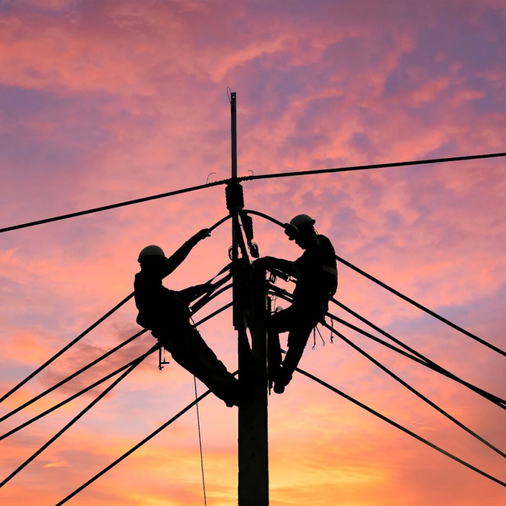 Power Line Safety Course. Images features two linemen on top of a telephone pole.